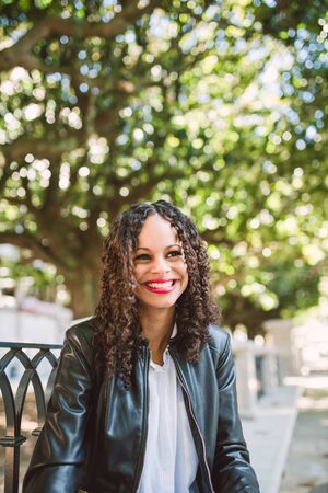 Portrait of a Latin American Afro Woman smiling outdoorsの写真素材