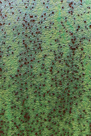 Metal wall green color with rust spotsの写真素材