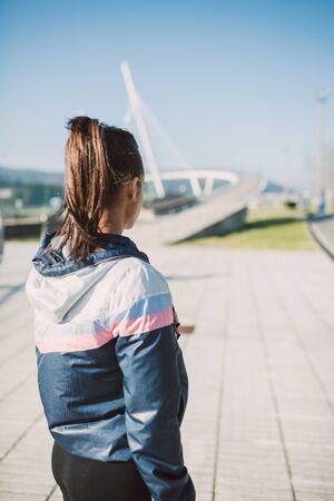 Runner female woman back outdoors with copy space on the rightの写真素材