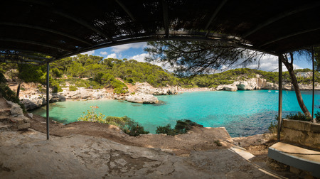 Cala Mitjana in a sunny summer day, Menorca, Spain.