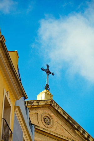 The cross on the roof of the buildingの写真素材