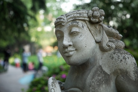 Stone statue of a god in a park in Shanghai, Chinaの写真素材