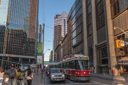 Toronto, Aug 2006 - Queen street is an area surrounded with tall modern glass buildings and busy trafficのeditorial素材