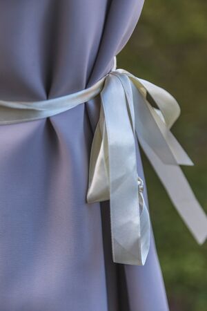Lavender colour curtain tied with white ribbonの写真素材