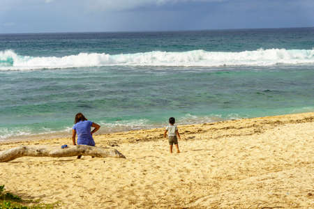 Woman and child have a good time by the seaのeditorial素材