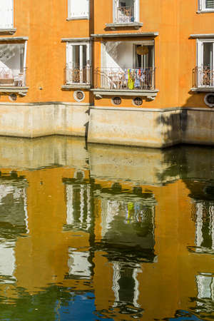 Apartment and reflection by an artificial lake resortのeditorial素材