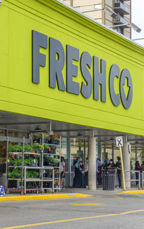 Customers line up outside Freshco grocery storeのeditorial素材