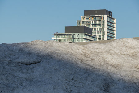 Snow plowed and collected into a mountain pile by the roadsideの写真素材