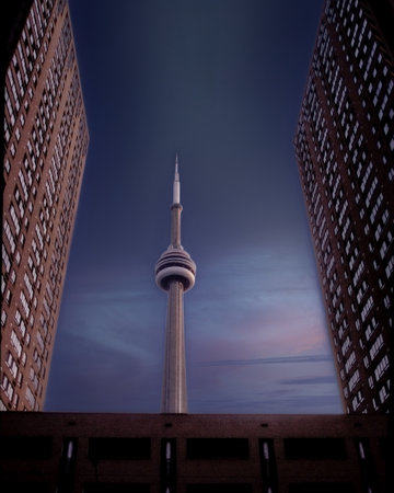 CN Tower viewed at sunset between two tall buildingsのeditorial素材