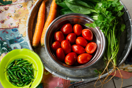 Aluminium trays and plastic plate with variety of fresh vegetablesの写真素材