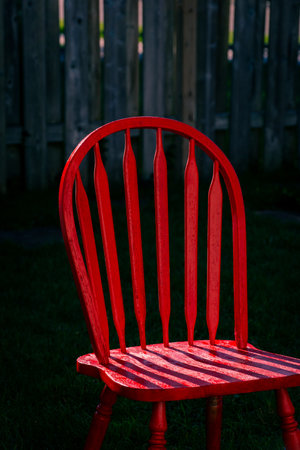 Red wooden chair in sunlightの写真素材