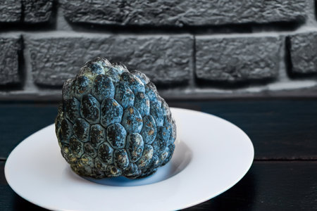 Sugar apple fruit on a white plate
