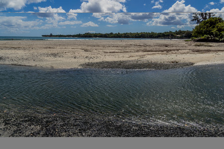 Tropical Coastal Sandbar Under Blue Skyの写真素材