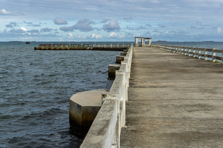 Concrete pier extending over calm oceanの写真素材
