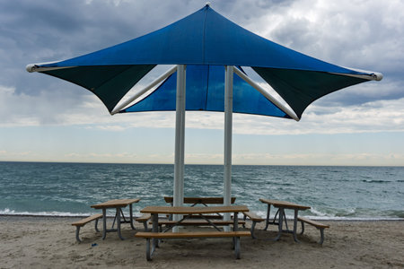 Blue canopy picnic shelter by the lakeの写真素材