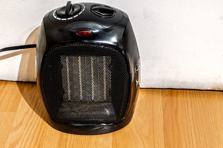 Compact electric space heater on wooden Floorの写真素材