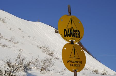 Warning signs of avalanche danger in front of Mount Roberts (Juneau, Alaska).の写真素材