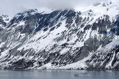Small ship passing by in Glacier Bay national park, Alaska.の写真素材