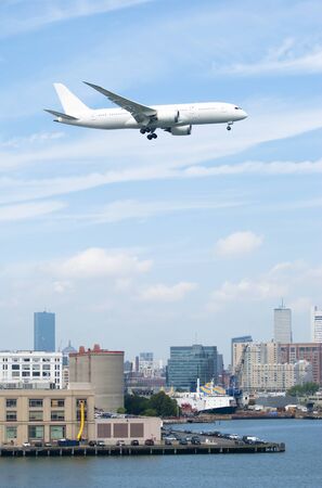 The huge plane is flying over Boston downtown towards the airport  Massachusetts  の写真素材
