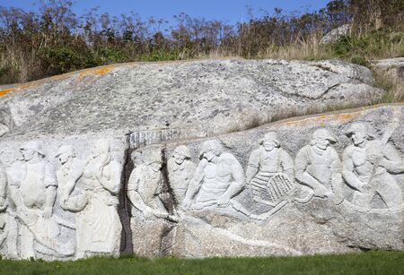 The stone relief in a village showing fishermen (Nova Scotia).の写真素材