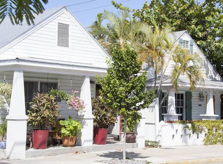 White color wooden houses full of greenery in Key West town (Florida).の写真素材