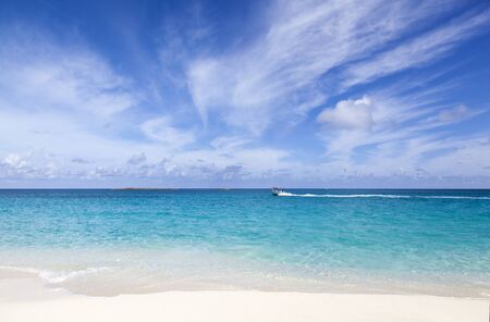 The view of Caribbean Sea with motorboat passing by (Paradise Island, The Bahamas).
