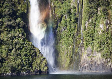 Milford Sound colored waterfall in Fiordland national park (New Zealand).の写真素材