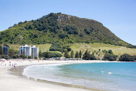 The beach in Mount Maunganui resort town with the same name mountain in a background (Tauranga, New Zealand).の写真素材