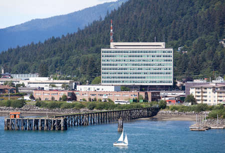 The small boat passing by the government building in Juneau, the capital of Alaska.の写真素材