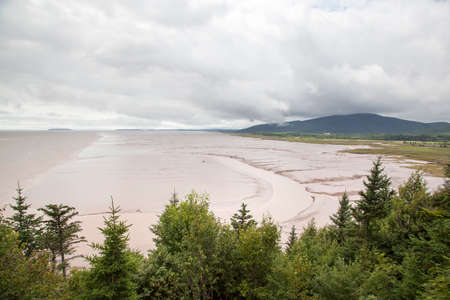 The view of St. Martins village Bay of Fundy beach famous for it's high sea tides (New Brunswick, Canada).の写真素材