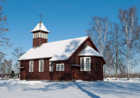 The wooden village church in Winter time (Lithuania).の写真素材