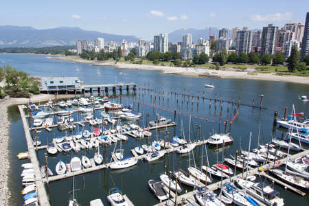 The view of marina in False Creek with Vancouver downtown in a background (British Columbia).の写真素材