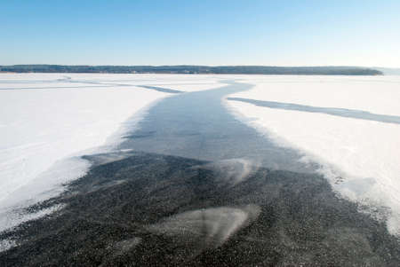 The curved path on the frozen artificial lake Kauno Marios (Lithuania).の写真素材