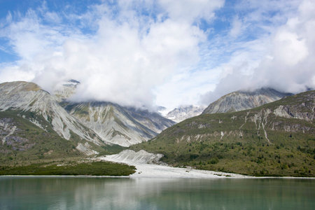 The scenic view with clouds over mountains in Glacier Bay national park (Alaska).の写真素材