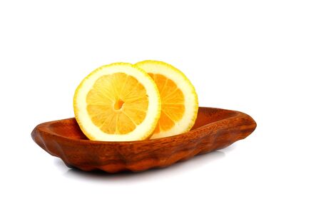 Slices of lemon on a wooden plate                                の写真素材