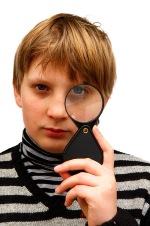 A boy looking through a magnifying glass on a white background                                の写真素材