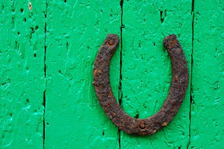 The old horseshoe on the old door                             の写真素材