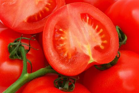 Ripe red  tomatoes on a green twig                               の写真素材