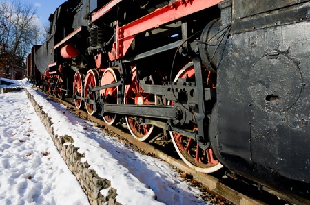 Old fashioned black - red locomotive as a monument   