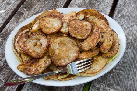 Fried zucchini with garlic closeup on a plateの写真素材