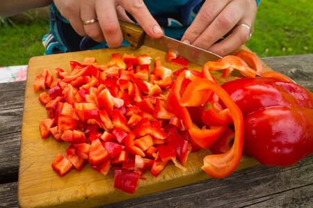 Preparation of vegetarian salad from fresh red peppers の写真素材
