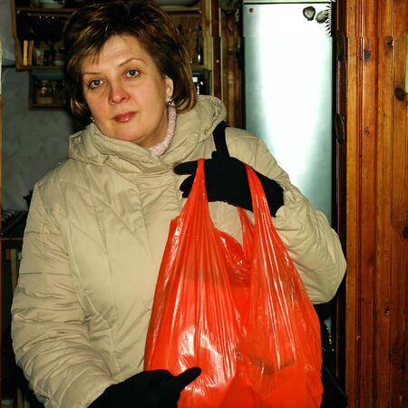 Beautiful woman with shopping bags in  handsの写真素材