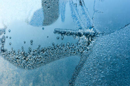 Closeup of beautiful frost pattern on a windowの写真素材