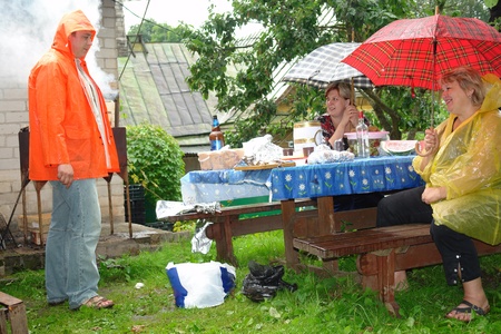 Family picnic on a rainy summer day                              の写真素材