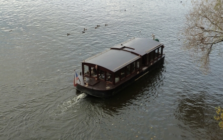 Old water bus floats on the river 