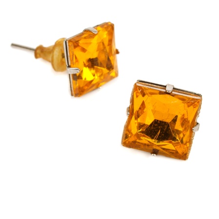 Earrings in yellow glass on a white backgroundの写真素材