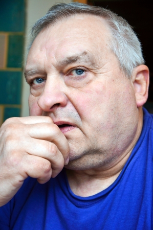 Portrait of an elderly man in a blue shirtの写真素材