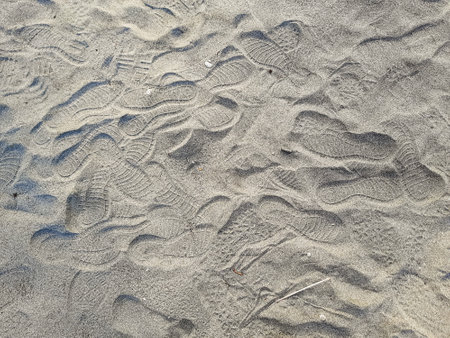 footprints from shoe patterns in the sand on the beachの写真素材