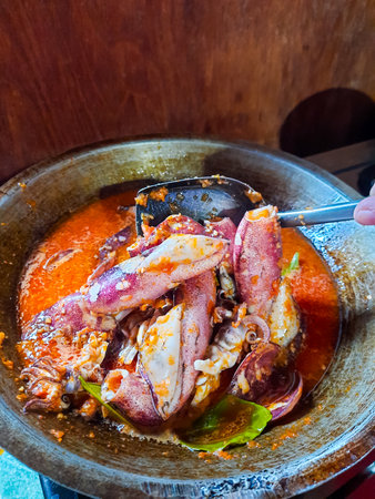 Cumi Balado or red chili squid. one of the typical Minangkabau dishes in Indonesia, fresh squid cooked with spicy chili sauce.の写真素材
