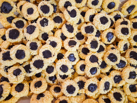 close-up of Indonesian butter cookies with a chocolate center, traditionally served during Eid al-Fitr. The golden cookies create a beautiful patternの写真素材